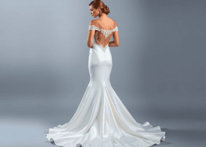 Stunning mermaid wedding dress in sumptuous satin fabric with dramatic train, open back design adorned with intricate lace appliqués, perfect for a timeless bridal look.