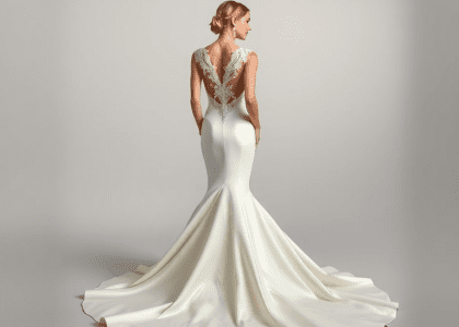 Mermaid wedding dress with sleek silhouette hugging the body and flaring out at the knee, made of luxurious satin, featuring an enchanting open back with delicate lace appliqués, complemented by an elegant train for a sophisticated and timeless look.