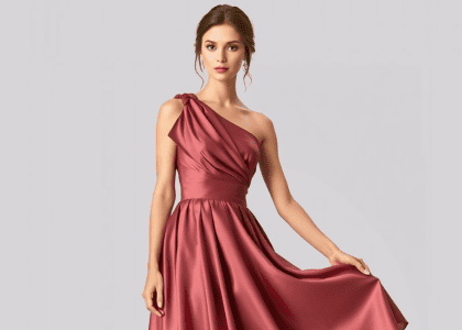 One-shoulder satin bridesmaid dress with delicate ruching, soft A-line skirt, and rich hue, showcasing timeless elegance and graceful silhouette for a wedding.